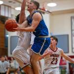 PHOTO BY FOREST WORGUM Elmas Traden Carter, right, goes up for a shot against Hoquiams Aiden Butcher during the Eagles 49-47 win on Tuesday at Hoquiam Square Garden.
