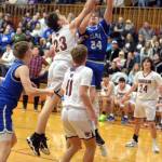 RYAN SPARKS | THE DAILY WORLD Elmas Carter Studer (24) drives to the basket against Hoquiams Chris Bryson (23) during the Eagles 49-47 win on Tuesday at Hoquiam Square Garden.