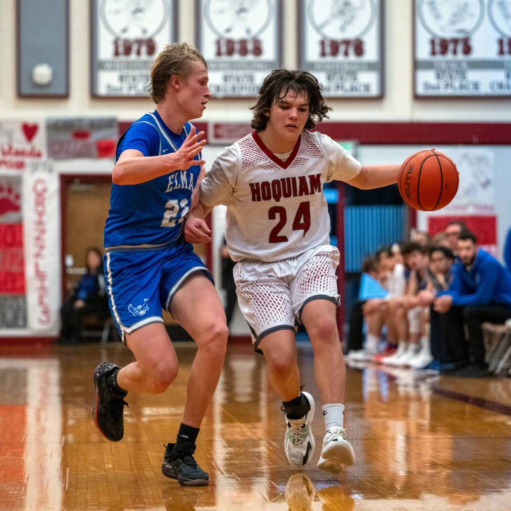 PHOTO BY FOREST WORGUM Hoquiams Lincoln Niemi (24) brings the ball up the court while Elmas Cason Seaberg defends during the Eagles 49-47 win on Tuesday in Hoquiam.