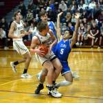 RYAN SPARKS | THE DAILY WORLD Elmas Theo Flores (5) draws a charge against Montesanos Peyton Damasiewicz during the Eagles 56-53 win on Tuesday at Montesano High School.