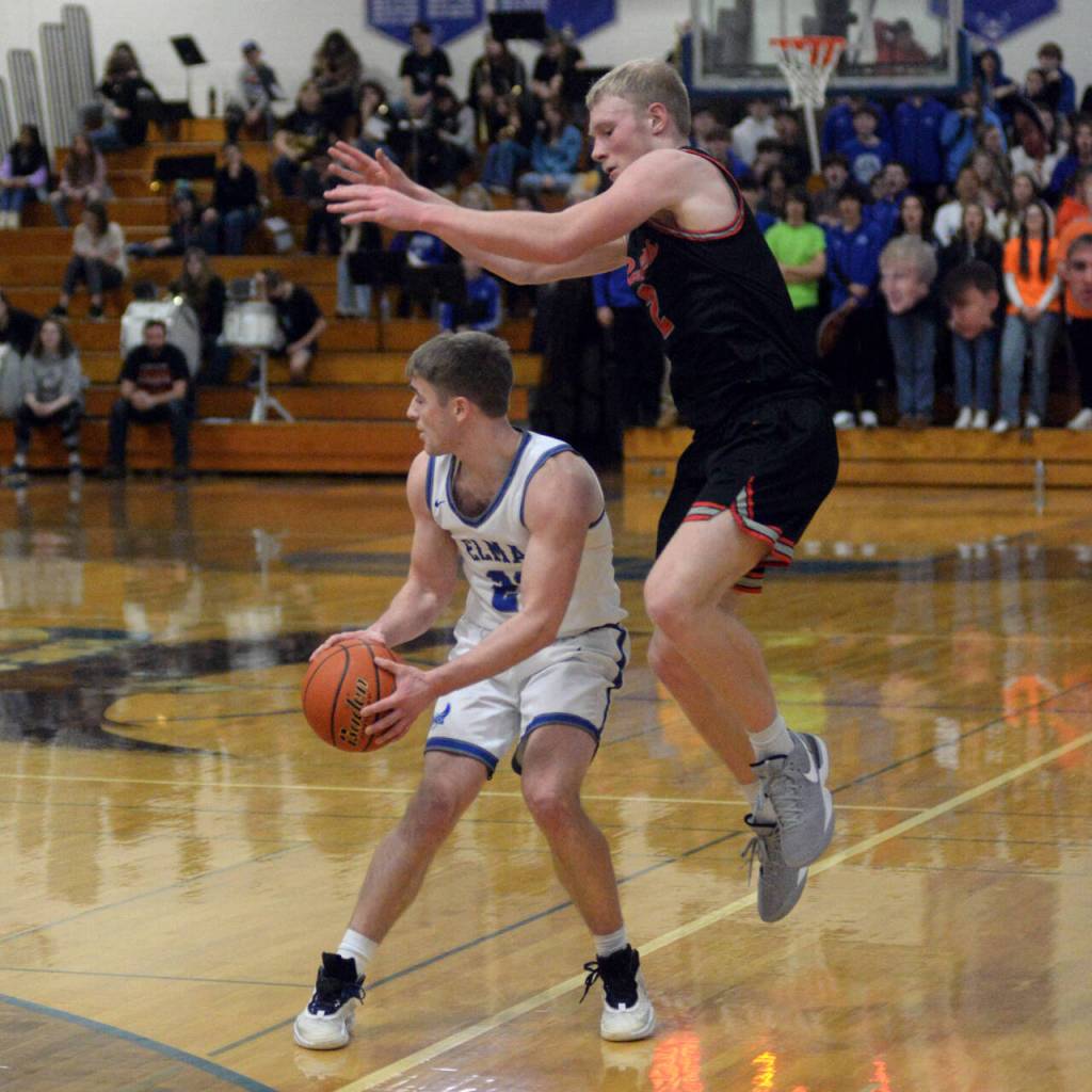 RYAN SPARKS | THE DAILY WORLD
Tenino's Austin Gonia, right, sails past Elma's Traden Carter during the Eagles' 55-52 loss on Thursday in Elma.