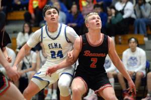 RYAN SPARKS | THE DAILY WORLD Elmas Carter Studer (24) and Teninos Austin Gonia ready for a rebound during the Eagles 55-52 loss on Thursday at Elma High School.