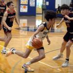 RYAN SPARKS | THE DAILY WORLD Aberdeens Isaac Garcia drives to the basket against Raymonds Dalton Welch, right, during the Bobcats 55-54 win on Saturday at Aberdeen High School.