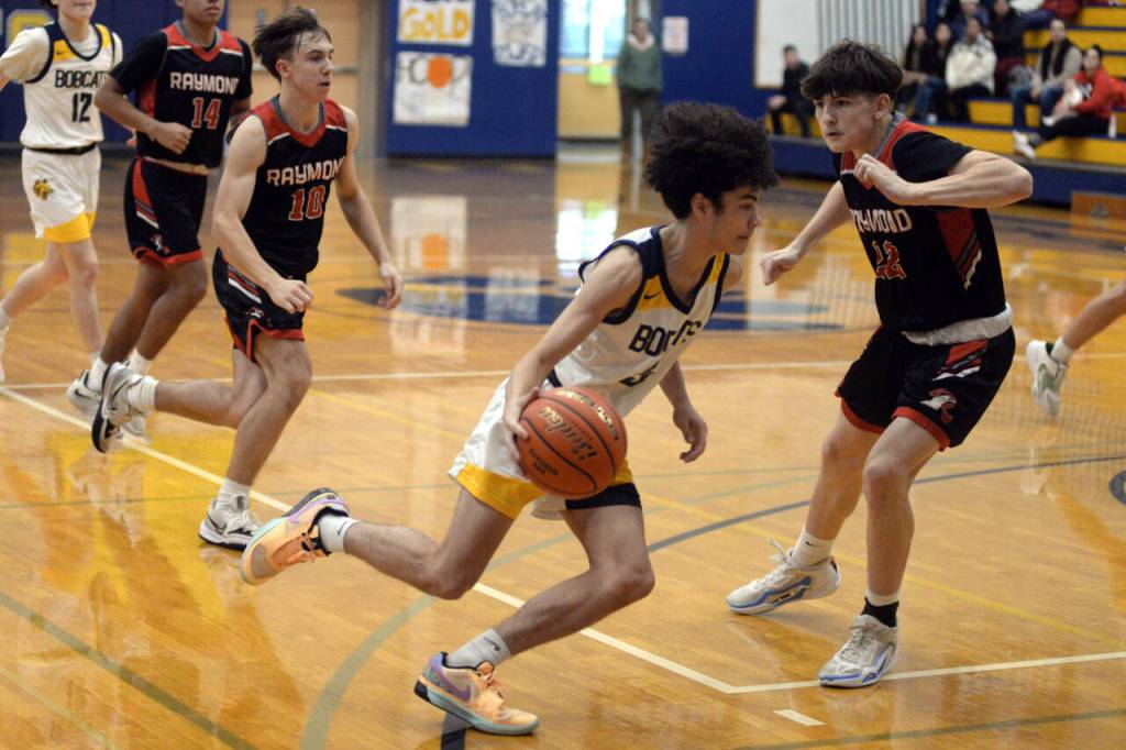 RYAN SPARKS | THE DAILY WORLD Aberdeens Isaac Garcia drives to the basket against Raymonds Dalton Welch, right, during the Bobcats 55-54 win on Saturday at Aberdeen High School.