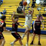 RYAN SPARKS | THE DAILY WORLD Aberdeen senior Patrick Walsh (3) drives to the hoop against Raymonds Taren Stephens, left, and Austin Snodgrass (20) during the Bobcats 55-54 victory on Saturday in Aberdeen.