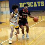 RYAN SPARKS | THE DAILY WORLD Raymonds Chris Quintana (14) is defended by Aberdeens Isaac Garcia during the Bobcats 55-54 win on Saturday in Aberdeen.