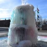 The currently colorful fountain that sits outside of Aberdeen City Hall  Heaven, man and Earth, by George Tsutakawa, which has been there since 1997  as seen from the east side of the fountain. The U.S. flag, Washington state flag and Aberdeen flag wave in the distance. The fountain is a popular attraction in Aberdeen and on Monday morning, its icy condition compelled pedestrians and drivers to stop and photograph and film it. (Matthew N. Wells / The Daily World)