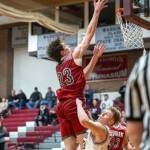 PHOTO BY FOREST WORGUM Hoquiam senior Chris Bryson (23) scores while Montesanos Tyce Peterson defends during the Grizzlies 65-61 overtime win on Tuesday in Montesano.