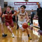 PHOTO BY FOREST WORGUM
Montesano's Delon Chan (21) dribbles past Hoquiam's Joey Bozich during the Bulldogs' 65-61 loss in overtime on Tuesday in Montesano.