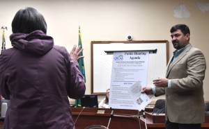 Montesano resident Donna Albert, left, talks with Dan Nelson, communications manager with the Olympic Regional Clean Air Agency, at a Jan. 16 public hearing at Hoquiam City Hall regarding a proposed wood pellet plant in Hoquiam.