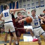 RYAN SPARKS | THE DAILY WORLD Hoquiams Zander Jump is fouled while being defended by Elmas Traden Carter (21) and Carter Studer (24) during the Eagles 60-49 win on Thursday at Elma High School.