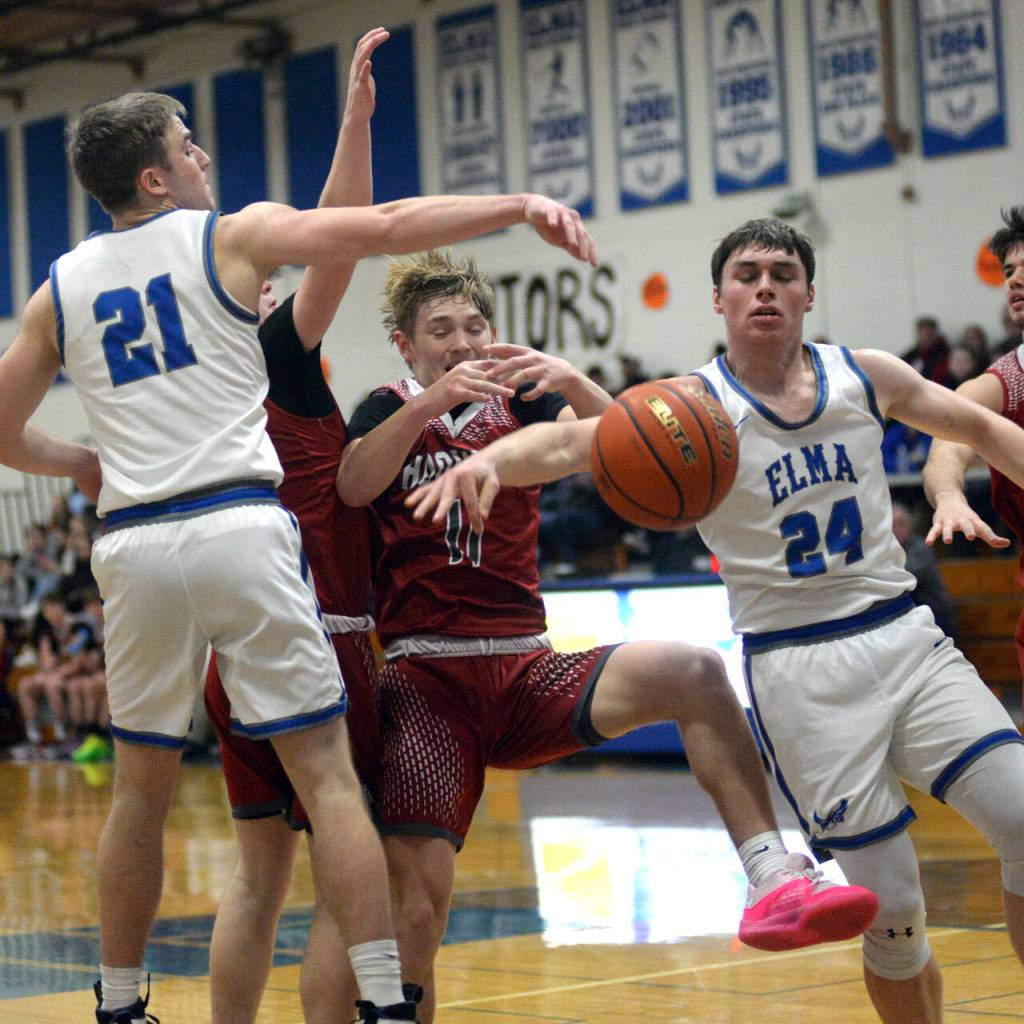 RYAN SPARKS | THE DAILY WORLD Hoquiams Zander Jump is fouled while being defended by Elmas Traden Carter (21) and Carter Studer (24) during the Eagles 60-49 win on Thursday at Elma High School.