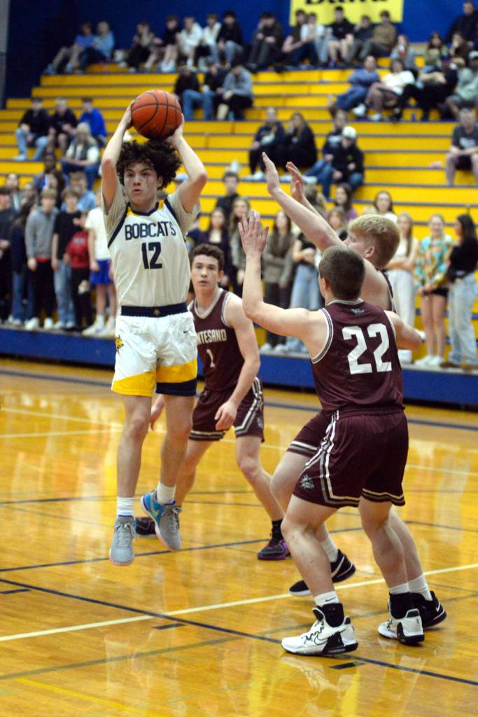 RYAN SPARKS | THE DAILY WORLD Aberdeens Manny Garcia (12) looks to pass against Montesanos Peyton Damasiewicz during the Bobcats 52-38 loss on Saturday in Aberdeen.