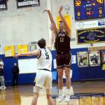 RYAN SPARKS | THE DAILY WORLD Montesano senior Gabe Bodwell (12) shoots while defended by Aberdeens Baylor Ainsworth during Montes 52-38 victory on Saturday at Aberdeen High School.
