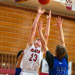 PHOTO BY FOREST WORGUM Hoquiam senior Chris Bryson leaps for a rebound against Eatonvilles Nate Goode, right, during the Grizzlies 79-44 win on Saturday in Hoquiam.