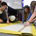 Clayton Franke / The Daily World
From left: Miller Junior High School 7th-graders Lapeace Reynolds, Korben OLague, Vanessa Sterling and Vada Wenzel prepare a poster with information about the 1920s and 30s on Friday, Jan. 19. The poster will be on display at the schools centennial celebration Sunday, Jan. 28.