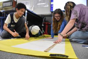 Clayton Franke / The Daily World
From left: Miller Junior High School 7th-graders Lapeace Reynolds, Korben OLague, Vanessa Sterling and Vada Wenzel prepare a poster with information about the 1920s and 30s on Friday, Jan. 19. The poster will be on display at the schools centennial celebration Sunday, Jan. 28.