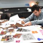 Clayton Franke / The Daily World
Anthony Ceja works on a poster displaying information about the 1960s and 70s on Friday Jan. 19. The poster will be on display during the Miller Junior High School centennial celebration Sunday, Jan. 28  which also happens to be Cejas birthday.