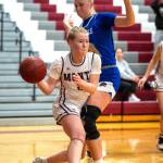 PHOTO BY FOREST WORGUM Montesano point guard Tieander Olson, left, is defended by Eatonvilles Lillian Bickford during the Bulldogs 58-39 win on Tuesday in Montesano.