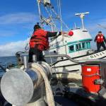 Coast Guardsmen toss a line to a disabled vessel before towing it in to Westport on Tuesday. (Courtesy photo / USCG)