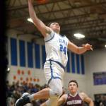 RYAN SPARKS | THE DAILY WORLD Elma senior Carter Studer (24) scores on a breakaway layup during the second half of a 59-59 loss to Montesano on Friday in Elma. Montes Terek Gunter (1) looks on.