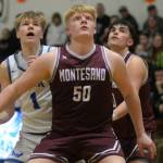 RYAN SPARKS | THE DAILY WORLD Montesanos Cam Taylor (50) Jaxson Wilson, right, compete for a rebound with Elmas Isaac McGaffey (1) during Montes 69-59 win on Friday in Elma.