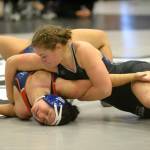 RYAN SPARKS | THE DAILY WORLD Grays Harbor Colleges Hailee Stoken, top, works to pin Utah Techs Ashley Lavarius during a 155-pound match at the NCWA Womens National Freestyle Invitational on Sunday at Hoquiam High School.