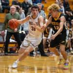 PHOTO BY FOREST WORGUM Montesanos Spencer Lovell (30) dribbles against North Beachs Parker Johnson during the Bulldogs 63-25 win on Tuesday in Montesano.