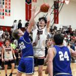 DYLAN WILHELM / THE CHRONICLE 
Noah Schow shoots over Elmas Cason Seaberg (22) during the Eagles 55-43 loss on Wednesday in Tenino.