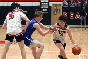DYLAN WILHELM | THE CHRONICLE
Preston Snider dribbles around a defender during Tenino's win over Elma on Jan. 31.