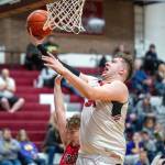 PHOTO BY FOREST WORGUM Raymond center Talan Yearout, right, drives to the hoop during a 60-49 loss to Toledo in a 2B District 4 Tournament first-round game on Saturday in Montesano.