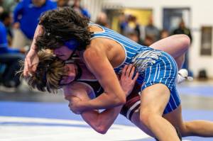PHOTO BY FOREST WORGUM Elmas Haven Wunsch, top, grapples with Montesanos Alex Salstrom in a 126-pound match at the 1A Evergreen Sub-Regionals on Saturday at Elma High School.