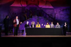Tamara Helland
The lead characters of The Addams Family sit down to a banquet dinner. From left, Ricky Estavillo (Lurch), Ivan Conley (Gomez), Robin Fabini (Fester), Kayden Scroggs (Grandma), Ana Aguilar (Wednesday), Dani Fleury (Alice Beineicke), Leo Coons (Mal Beineicke), Landon Mathews (Pugsley) and Audrey Paylor (Morticia).