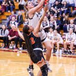 RYAN SPARKS | THE DAILY WORLD Raymond-South Bends Kassie Koski drives to the hoop while defended by Rainiers Jazzlyn Shumate during the Ravens 70-48 loss in the 2B District 4 Tournament on Tuesday in Montesano.