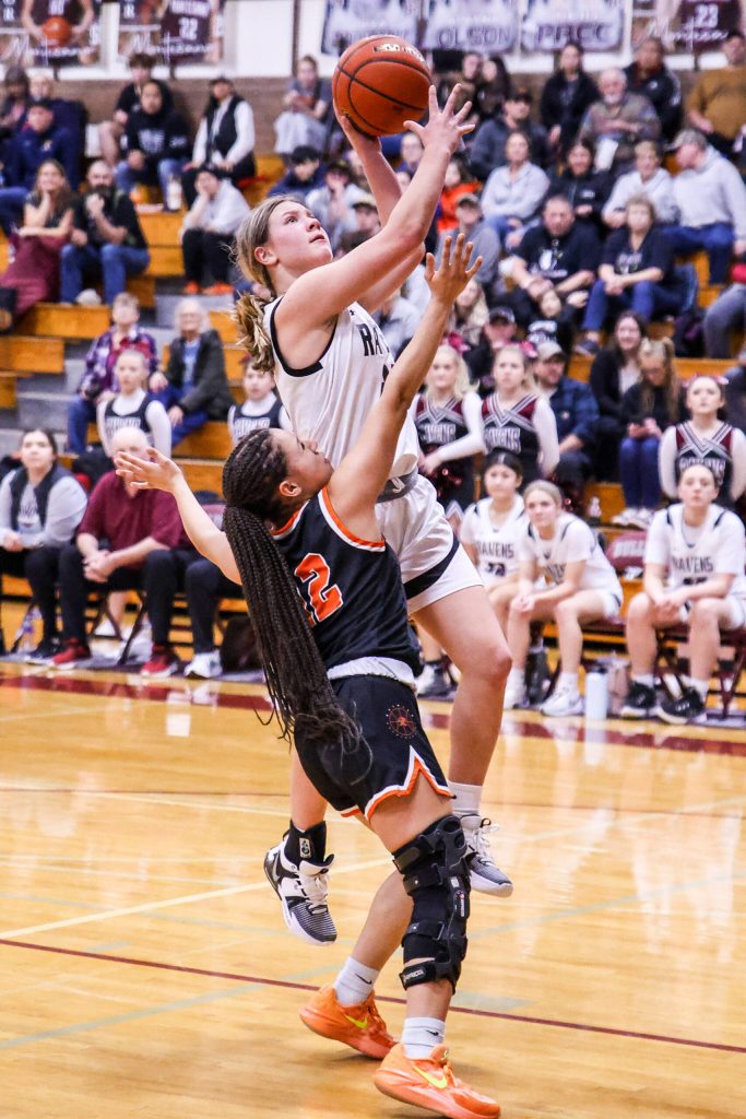 RYAN SPARKS | THE DAILY WORLD Raymond-South Bends Kassie Koski drives to the hoop while defended by Rainiers Jazzlyn Shumate during the Ravens 70-48 loss in the 2B District 4 Tournament on Tuesday in Montesano.