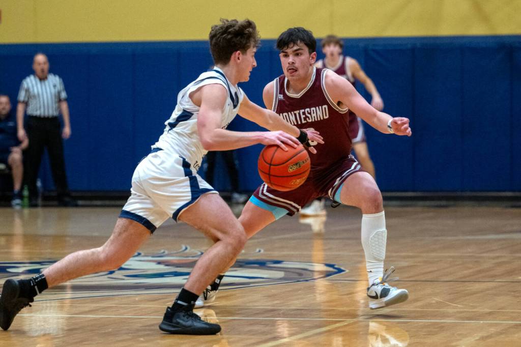 PHOTO BY FOREST WORGUM Montesano senior Jaxson Wilson, right, defends a Seton Catholic player during the Bulldogs 58-46 loss in a 1A District 4 Tournament semifinal game on Friday in Vancouver.