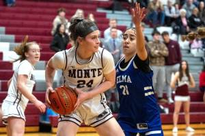 PHOTO BY FOREST WORGUM Montesanos Jillie Dalan (24) is defended by Elmas Malia Sibbett during the Bulldogs 37-22 win in a 1A District 4 semifinal game on Saturday in Montesano.