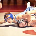 PHOTO BY SUE MICHALAK BUDSBERG Elmas Aidyn Johnson, left, works to pin Montesanos Adam Schmitz during the 113-pound final of the WIAA Region 2 Tournament on Saturday at Hoquiam High School.
