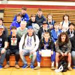 PHOTO BY SUE MICHALAK BUDSBERG Elma head coach Jeff Catterlin (front row, third from left) is surrounded by his team after the Eagles placed second at the WIAA Region 2 Tournament on Saturday at Hoquiam High School.