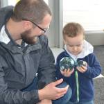 Two "float wranglers" inspect their treasures prior to their Feb. 16 release into the dunes of the North Beach ahead of the Beachcombers and Glass Float Expo, March 1-3, 2024. (Photo by John Shaw)
