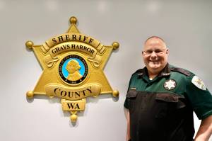 Michael S. Lockett / The Daily World
Sheriff Darrin Wallace stands alongside the agencys new crest in their Montesano headquarters.