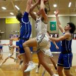 RYAN SPARKS | THE DAILY WORLD Montesano senior Gabe Bodwell, middle, drives to the basket against La Centers Austin Nixon, left, during the Bulldogs 70-61 victory on Wednesday at Rochester High School.