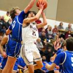 RYAN SPARKS | THE DAILY WORLD Montesanos Delon Chan (21) is fouled by La Centers Austin Nixon (12) during the Bulldogs 70-61 victory in a 1A District 4 Tournament game on Wednesday at Rochester High School.