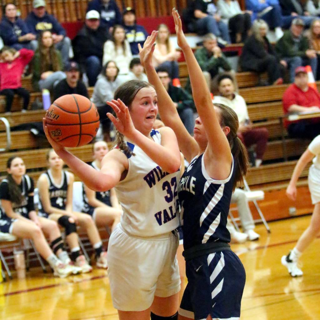 RYAN SPARKS | THE DAILY WORLD Willapa Valleys Tylar Keeton (32) looks to pass while defended by Naselles Brooke Davis during the Vikings 44-34 win in a 1B District 4 Tournament game on Thursday in Hoquiam.