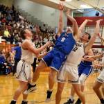 PHOTO BY FOREST WORGUM Elma junior guard Traden Carter (0) looks to draw a foul against Montesanos Gabe Bodwell (12) during the Bulldogs 63-54 win in the 1A District 4 third-place game on Saturday at Hoquiam High School.