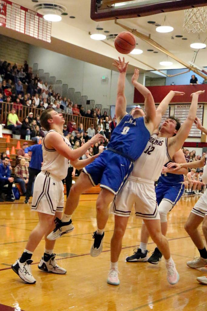 PHOTO BY FOREST WORGUM Elma junior guard Traden Carter (0) looks to draw a foul against Montesanos Gabe Bodwell (12) during the Bulldogs 63-54 win in the 1A District 4 third-place game on Saturday at Hoquiam High School.