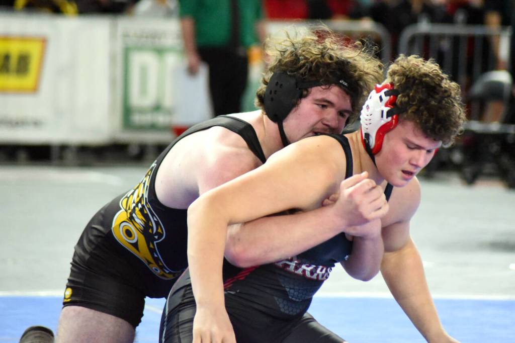 PHOTO BY SUE MICHALAK BUDSBERG North Beachs Adin Wollum, left, wrestles against Alimira Coulee Hartlines Noah Butler in a 1B/2B 215-pound semifinal match at the Mat Classic XXXV on Saturday at the Tacoma Dome.