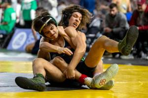 PHOTO BY FOREST WORGUM Hoquiams Kingston Case, background, wrestles against Toppenishs Anthony Sifuentes during a 1A 138-pound match at the Mat Classic XXXV on Friday at the Tacoma Dome.