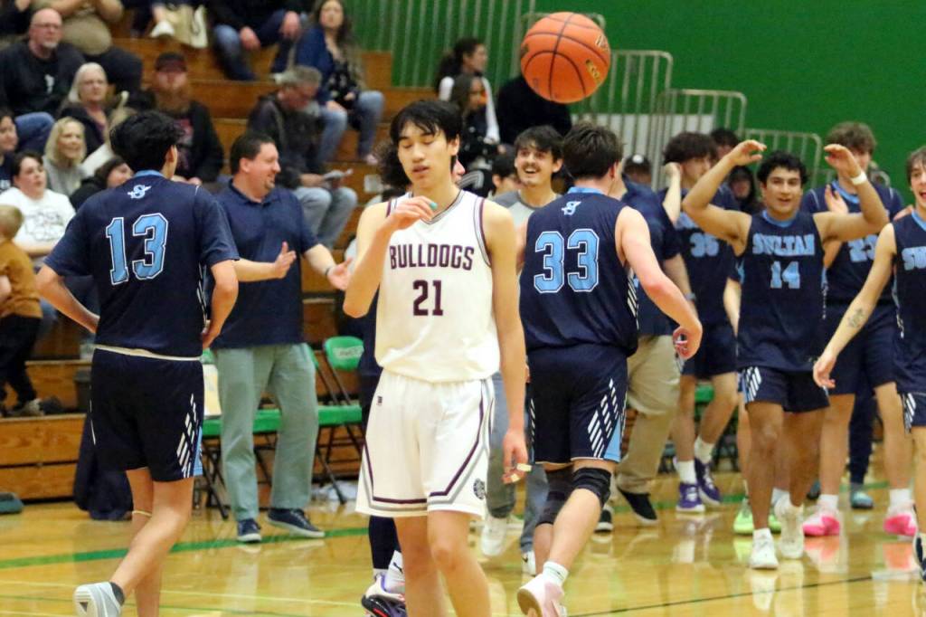 RYAN SPARKS | THE DAILY WORLD Montesano guard Delon Chan (21) tosses the ball away as the final buzzer sounds in the Bulldogs 69-54 loss to Sultan in a 1A State Tournament first-round game on Saturday at Tumwater High School.