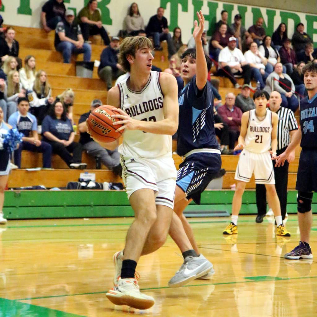 RYAN SPARKS | THE DAILY WORLD Montesano center Soren Cobb, left, looks to pass during the Bulldogs 69-54 loss to Sultan in a 1A State Tournament first-round game on Saturday at Tumwater High School.